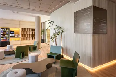 a waiting room with chairs and a chalkboard on the wall at B&B HOTEL Valencia Arena in Valencia