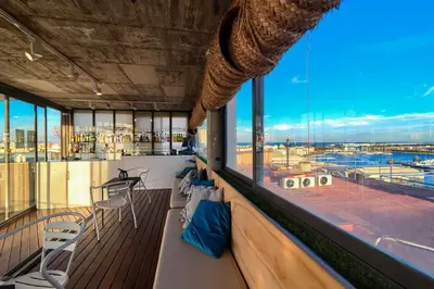 a balcony with a view of a harbor seen through a window at Sea You Hotel Port Valencia in Valencia