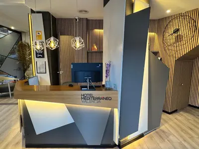 a lobby with a reception desk in a building at Hotel Mediterraneo Valencia in Valencia