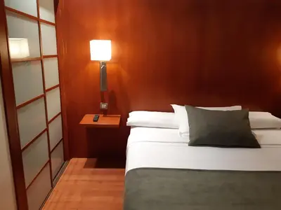 a bedroom with a bed and a lamp on a table at Hotel Xon's Valencia in Aldaya