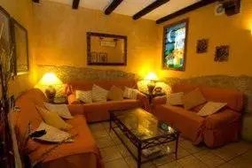 a living room with two couches and two tables at Hotel Rioja in Benisanó