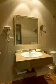 a bathroom with a sink and a mirror and a toilet at Hotel Rioja in Benisanó