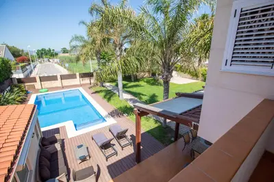 a view of a pool from a balcony of a house at Casa junto al mar con jardín in Sagunto
