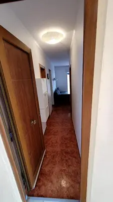 a hallway leading to a room with a door at appartement pied dans l eau in El Brosquil