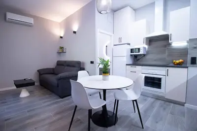 a kitchen and living room with a table and chairs at Patacona by Concept Flats in Valencia
