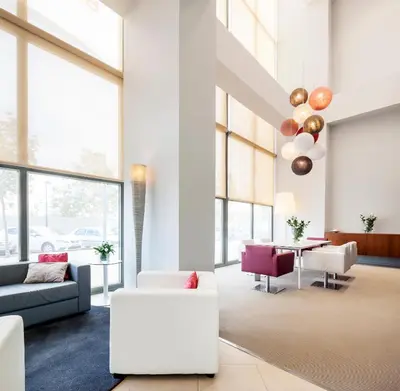 a dining room with tables and chairs in a building at Ilunion Valencia 3 in Valencia