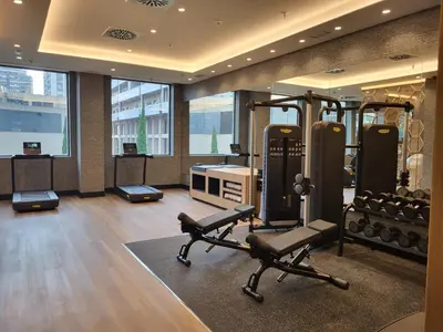 a gym with several treadmills and elliptical machines at Ilunion Valencia 3 in Valencia