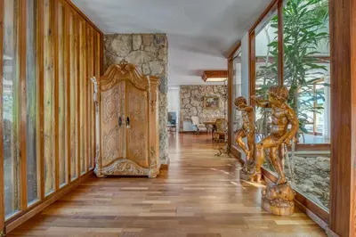 a hallway with a large wooden door in a house at Villa Montgrau in Llano de Gorra