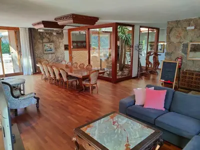 a living room with a blue couch and a table at Villa Montgrau in Llano de Gorra