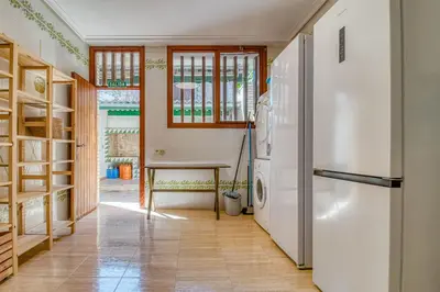 a kitchen with a refrigerator and a table at Villa Montgrau in Llano de Gorra