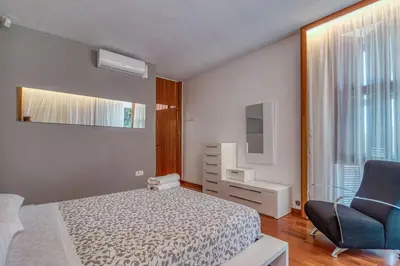 a bedroom with a bed and a chair and a television at Villa Montgrau in Llano de Gorra