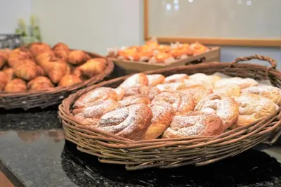 a bunch of donuts in baskets on a counter at Port Feria Valencia in Valencia