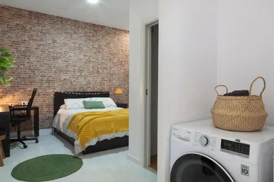a bedroom with a bed and a washing machine at Digital Nomad Retreat 2 -Great Location Near Metro in Valencia