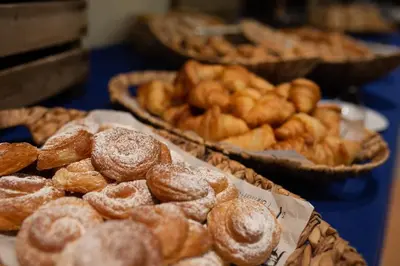 a bunch of donuts in baskets on a table at Flag Hotel Valencia in Masalfasar