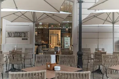 an empty restaurant with tables and chairs and umbrellas at SH Ingles Boutique Hotel in Valencia