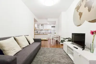 a living room with a couch and a television at Modern apartment in Valencia 56 m² with air conditioning in Valencia