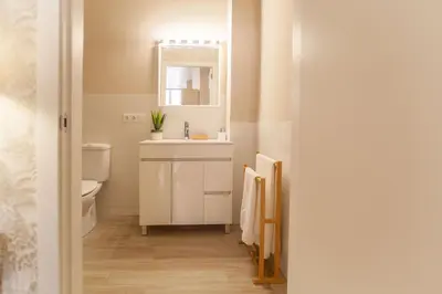 a bathroom with a sink and a toilet and a mirror at MD Patacona Beach Mid-term in Valencia