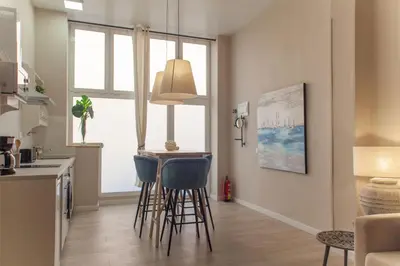a kitchen with stools and a table in a room at MD Patacona Beach Mid-term in Valencia