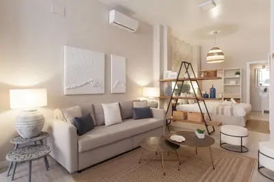 a living room with a couch and a table at MD Patacona Beach Mid-term in Valencia