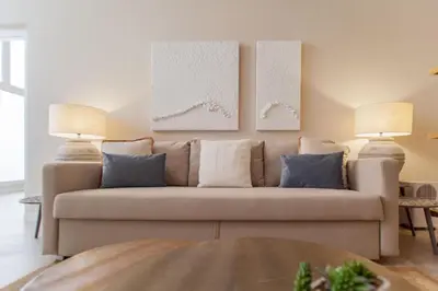 a living room with a couch and two lamps at MD Patacona Beach Mid-term in Valencia