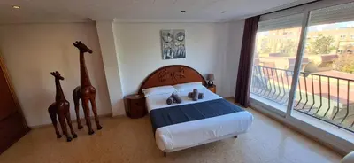 a bedroom with a bed with two giraffes on it at Gracioso apartamento en Massanassa in Benetúser