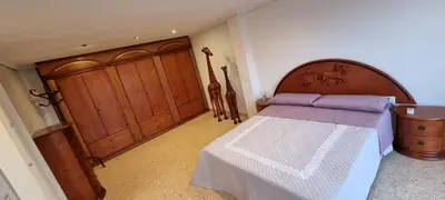 a bedroom with a bed and a wooden door at Gracioso apartamento en Massanassa in Benetúser
