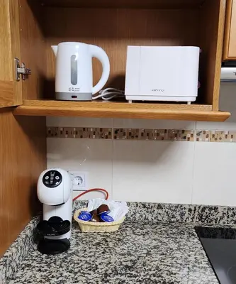 a kitchen counter with a coffee maker and a toaster at Magnifico apartamento en Burriana in Burriana