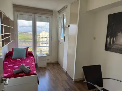 a small bedroom with a bed and a window at Spacious Apartment in Valencia with Sea View - 160 sqm in Valencia