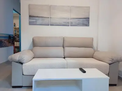 a living room with a couch and a coffee table at Apartamento en la playa las arenas +Wifi+AC in Valencia