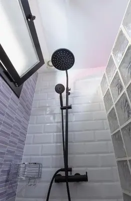 a shower in a bathroom with a shower at Artsy Large Getaway - 2 Bedroom w HUGE patio - Great for families and Digital Nomads in Valencia