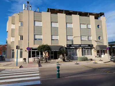 a large building with a crosswalk in front of a street at Hostal GARDEN ROUS in Paiporta