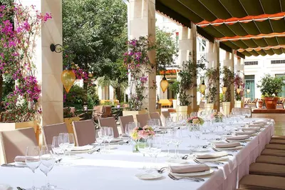 a long table with wine glasses and flowers on it at The Westin Valencia in Valencia