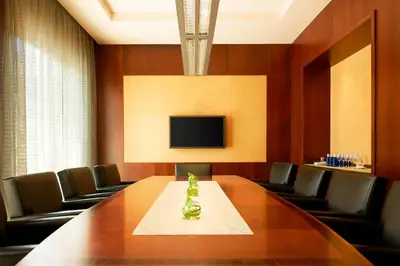 a conference room with a table and chairs and a tv at The Westin Valencia in Valencia