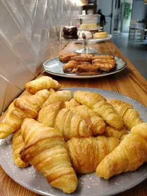 a table with plates of croissants and other food at YOU & CO. J. Botánico Boutique in Valencia