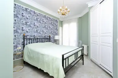 a bedroom with a bed and a floral wall at Joaquín Sorolla in Valencia