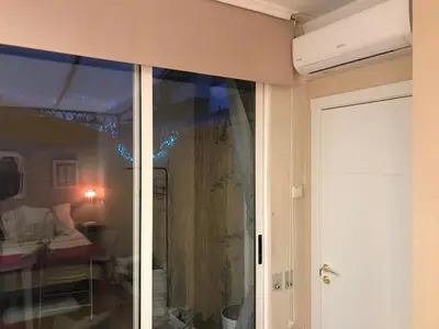a sliding glass door in a room with a bedroom at Habitación Apartamento Suite Papillon in Valencia