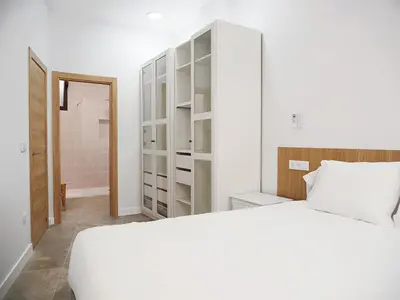 a bedroom with a white bed and a closet at Hotel Casbah in El Puig