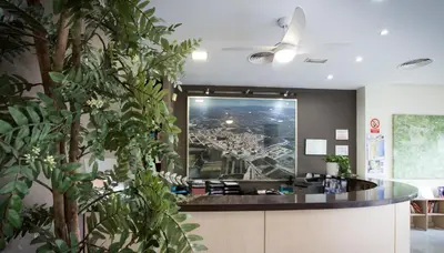 an office lobby with a large picture of a city at Hotel Casbah in El Puig
