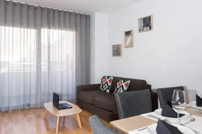 a living room with a couch and a table at Valenciaflats Ciudad de las Ciencias in Valencia