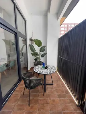 a room with a table and chairs on a floor at Maravilloso Loft junto a Ciudad de Artes y Ciencia in Valencia