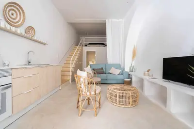 a living room with a blue couch and a table at Exclusivo Loft con terraza en Ciudad Artes y Cienc in Valencia