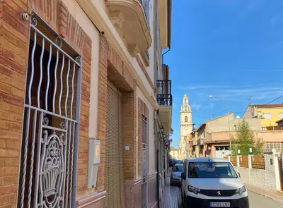 a car parked on a street next to a building at Casa Rural Frigols in Chella