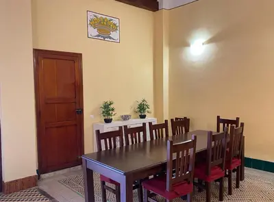 a dining room with a wooden table and chairs at Casa Rural Frigols in Chella