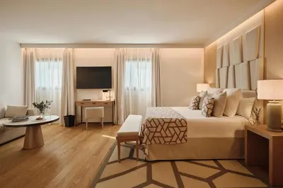 a hotel room with a large bed and a desk at Hospes Palau de La Mar, Valencia, a Member of Design Hotels in Valencia