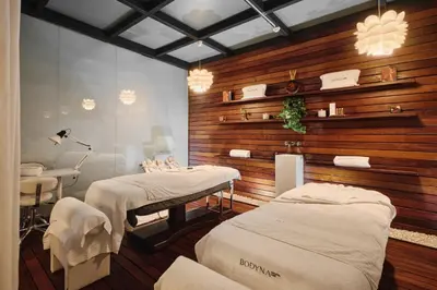 a hospital room with two beds and a table at Hospes Palau de La Mar, Valencia, a Member of Design Hotels in Valencia