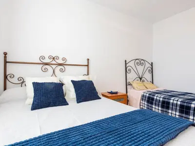 a bedroom with two beds with blue and white pillows at Apartment Jardimar by Interhome in Moncófar
