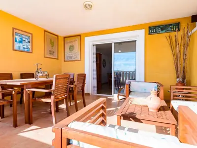 a living room with a table and chairs and a dining room at Apartment Jardimar by Interhome in Moncófar