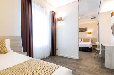 a hotel room with a bed and a desk in a room at Sweet Hotel Continental in Valencia