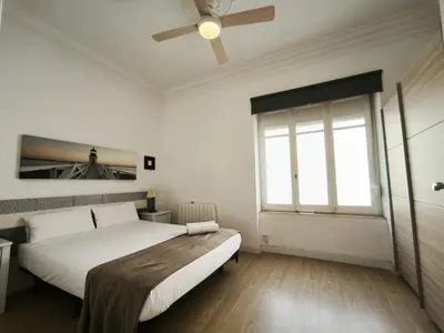 a bedroom with a bed and a ceiling fan at FLORIT FLATS - The Ausias March Apartment in Valencia