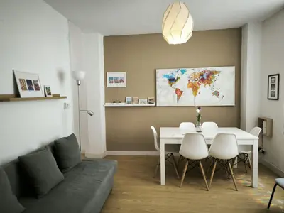a living room with a white table and a couch at FLORIT FLATS - The Ausias March Apartment in Valencia